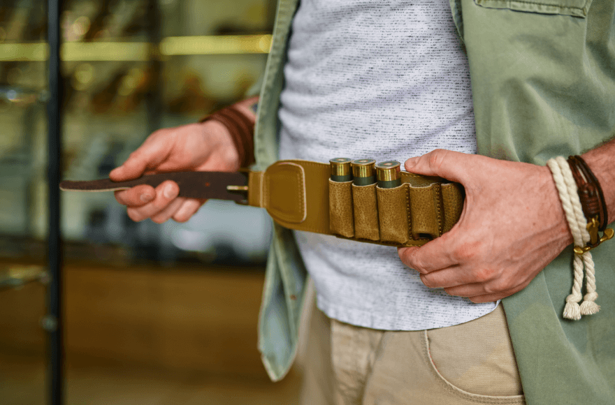 Man in a Gun Store Trying Gun Accessories